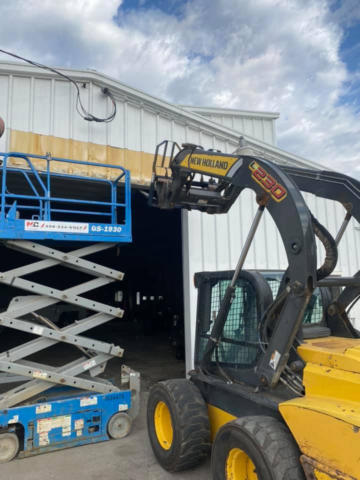 Commercial shop siding repair with skid steer Eastern Montana